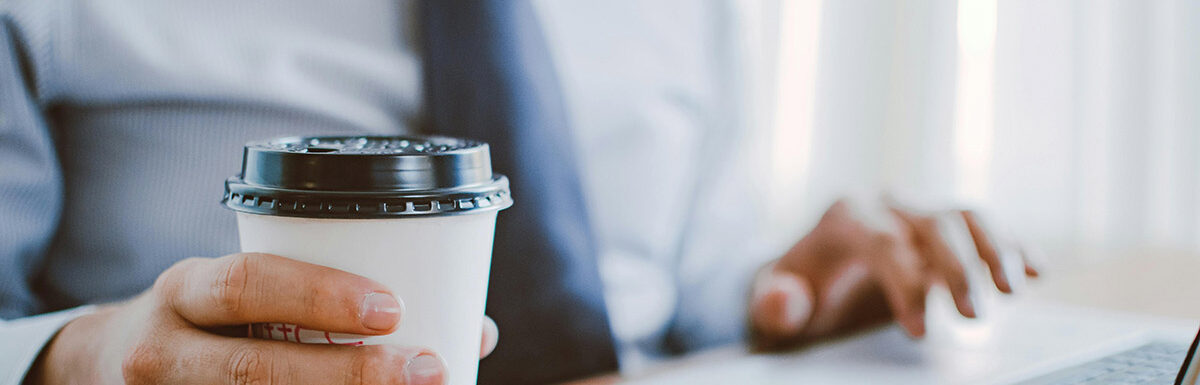 man with a coffee looking up business directoires