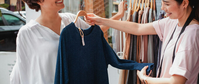 women shopping for clothes and showing consumer behavior